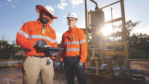 QGC wellsite operators check well performance.