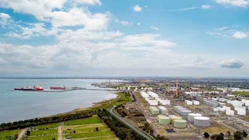 Aerial view of the Geelong Refinery and surrounding storage tanks and coastline.