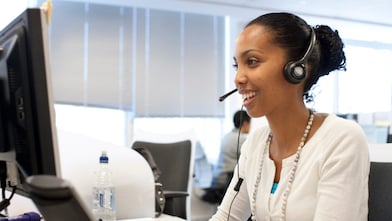 Woman in call centre facing her computer screen