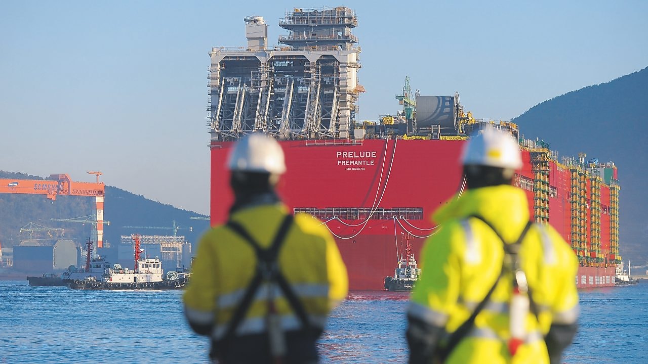 Two Shell employees looking at the big ship
