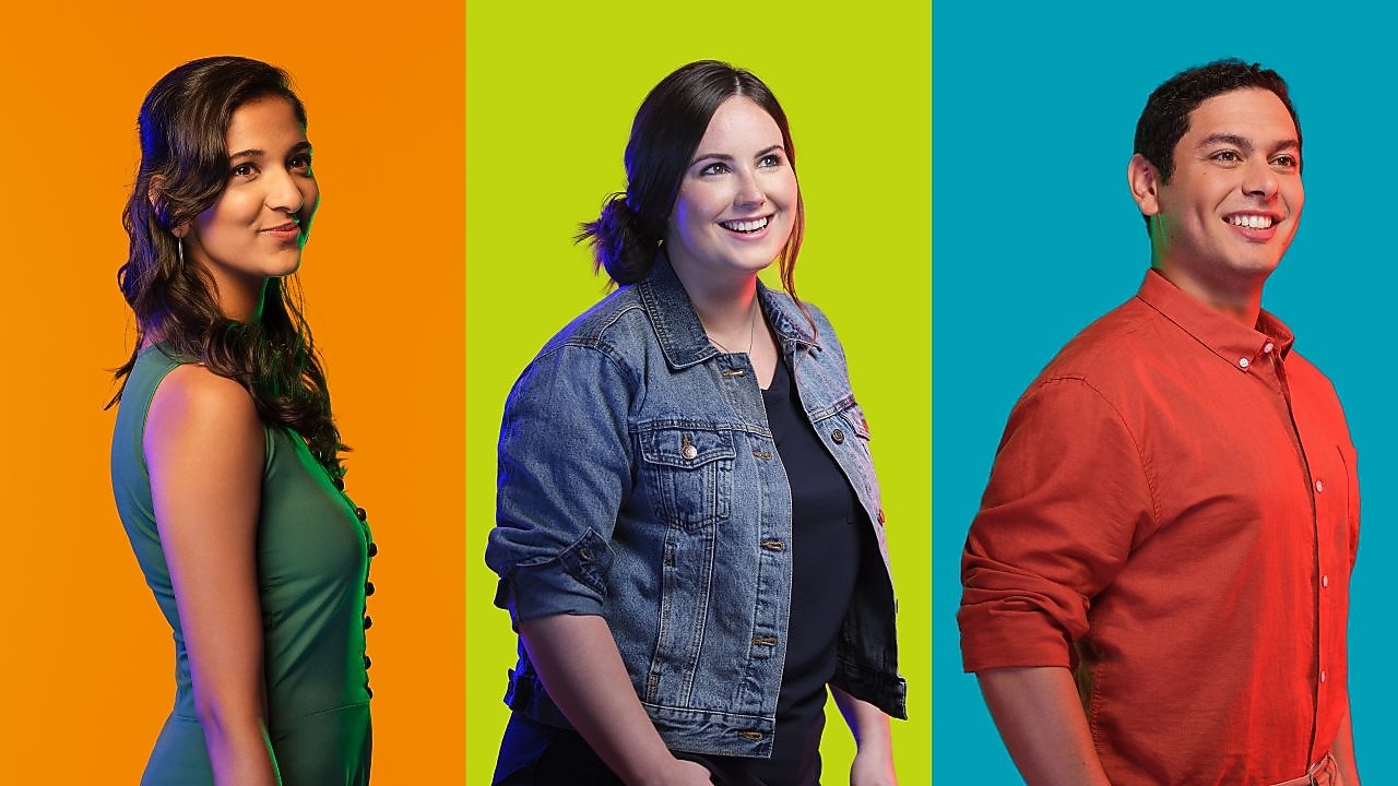 three employees smiling