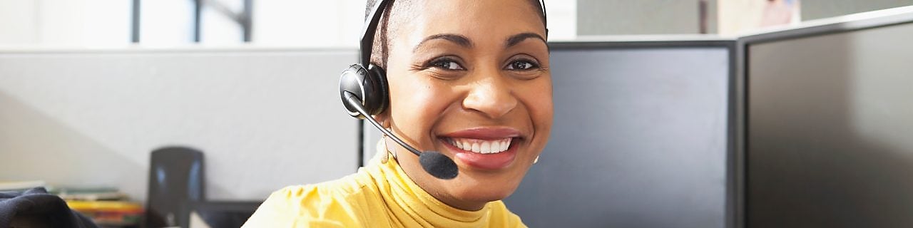 Woman in call centre facing her computer screen