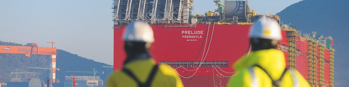 Two Shell employees looking at the big ship