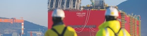 Two Shell employees looking at the big ship