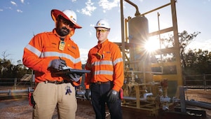 QGC wellsite operators check well performance.