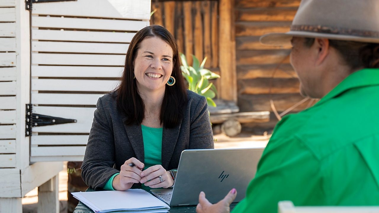 QGC employee engaging with community members.