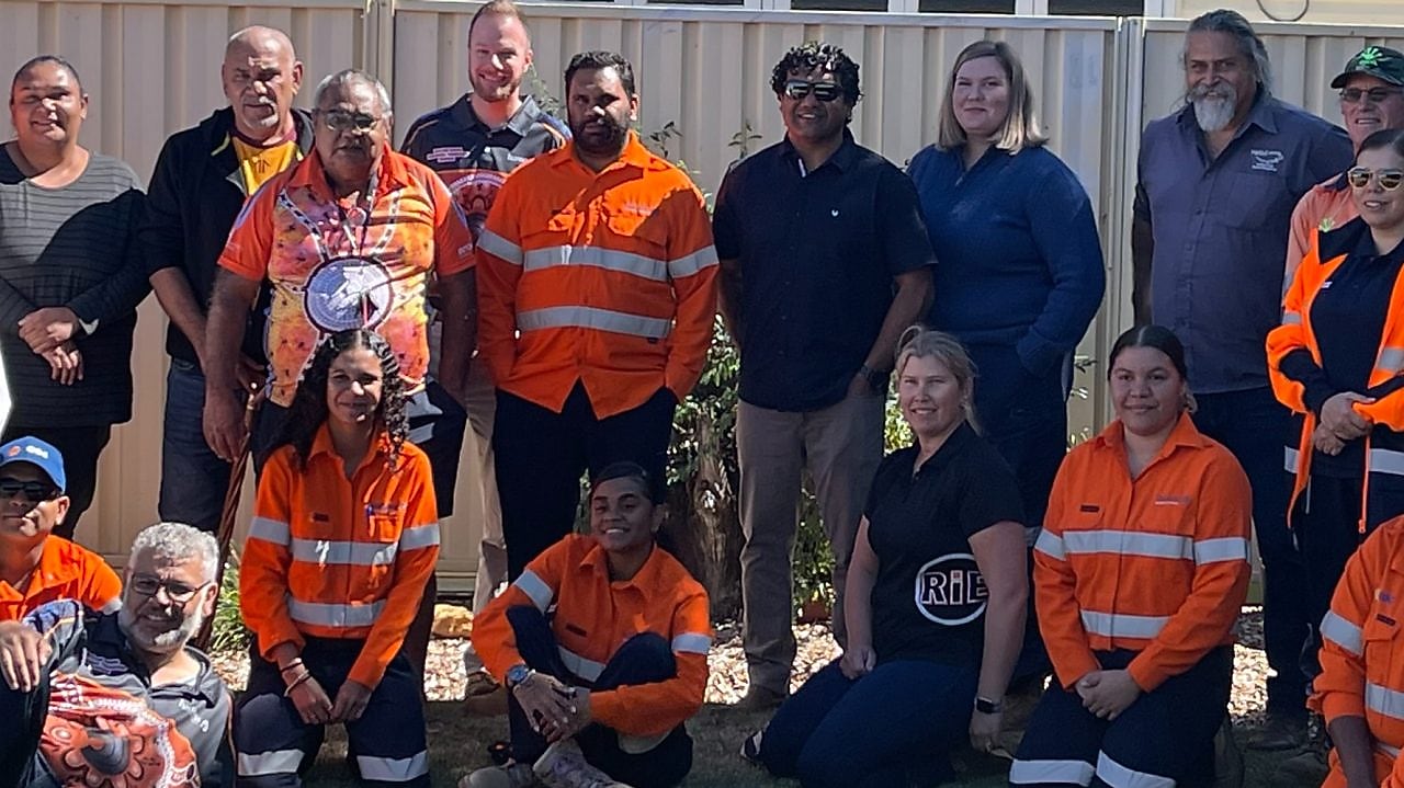 worker on a site writing on a paper while standing