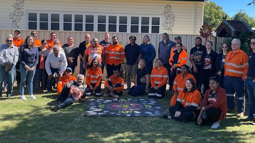 worker on a site writing on a paper while standing