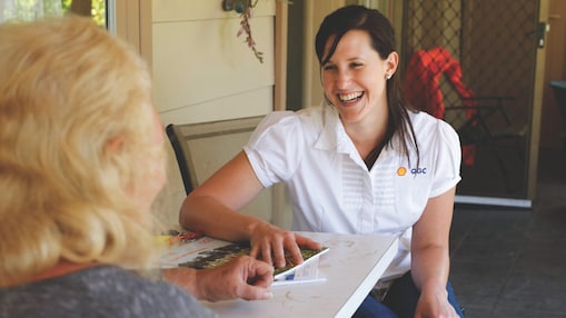 QGC employee sitting talking with landholder
