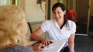 QGC employee sitting talking with landholder