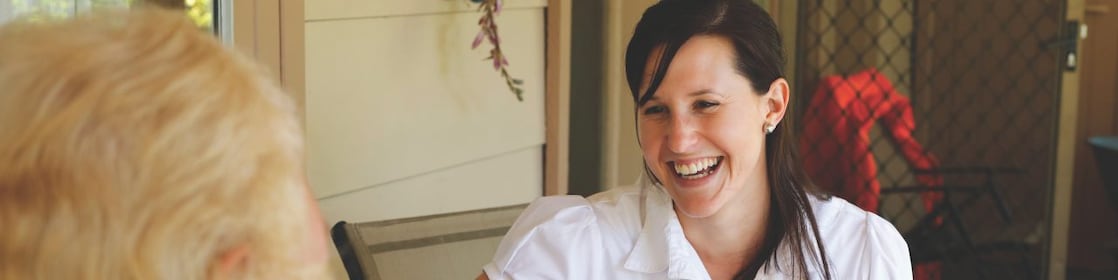QGC employee sitting talking with landholder