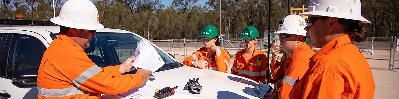 QGC employee at work near Car