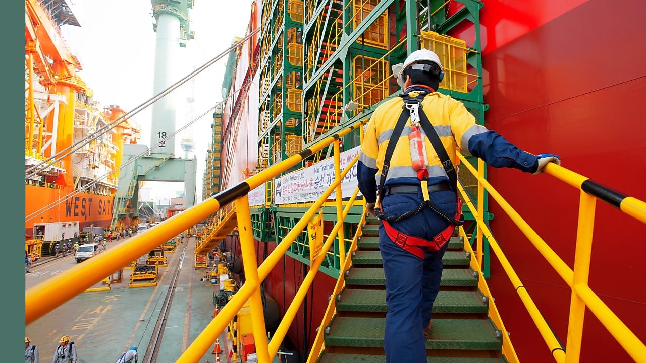 a-prelude-flng-worker-boarding-the-prelude-flng-facility-in-the-samsung-heavy-industries-yard-in-geoje-south-korea