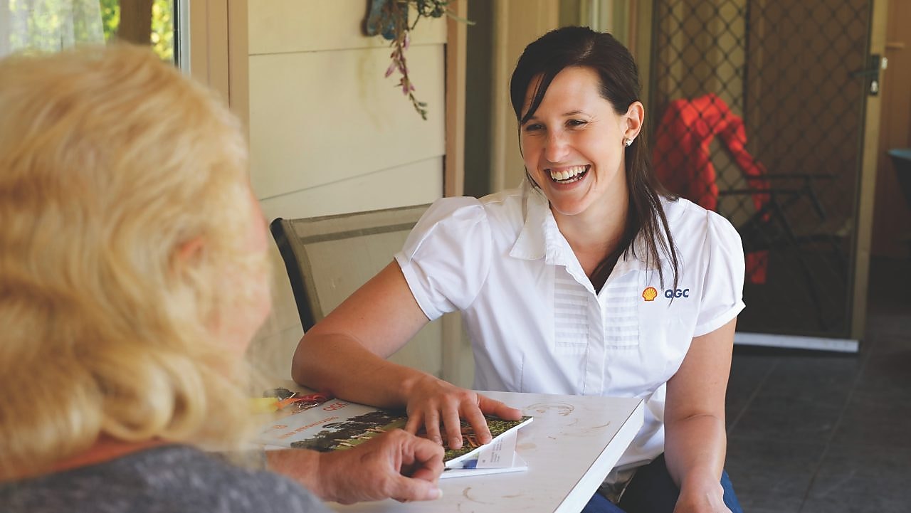 QGC employee sitting talking with landholder