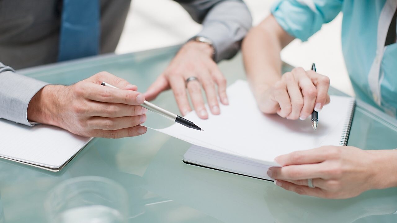 businessman and businesswoman reviewing paperwork