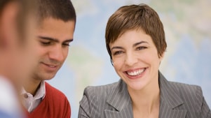 Business people having meeting over blueprints