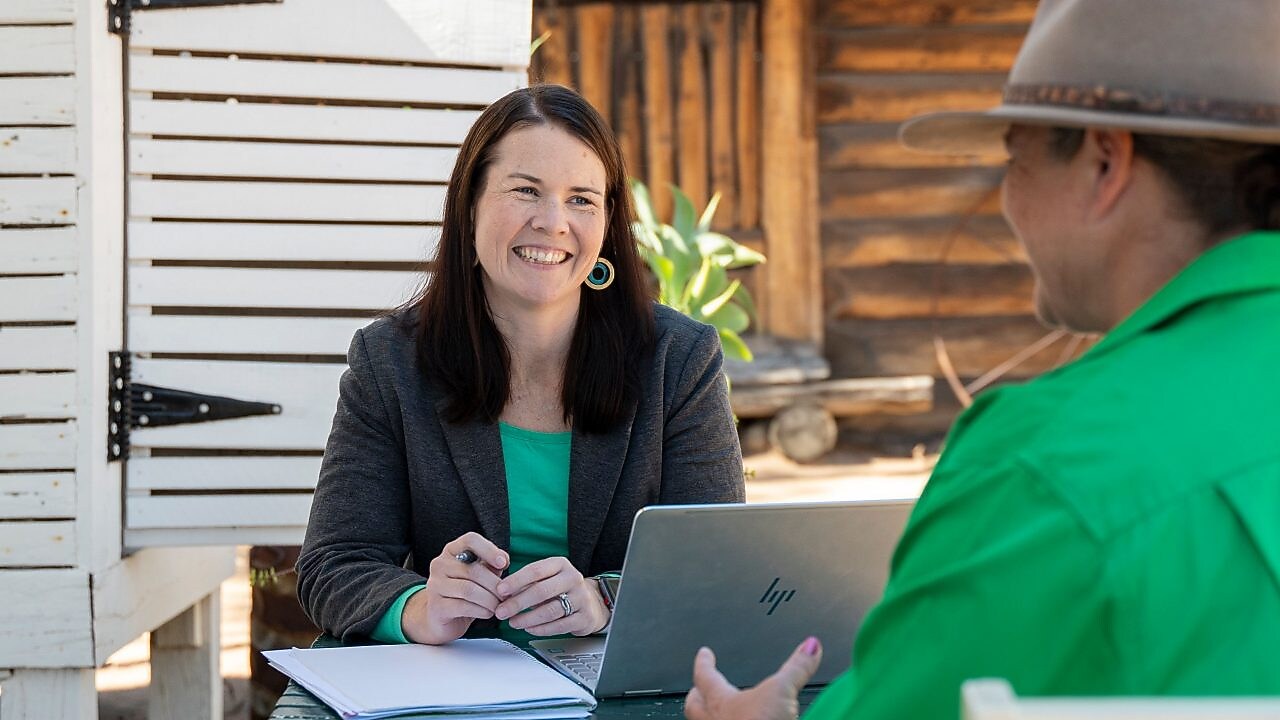QGC employee engaging with community members.