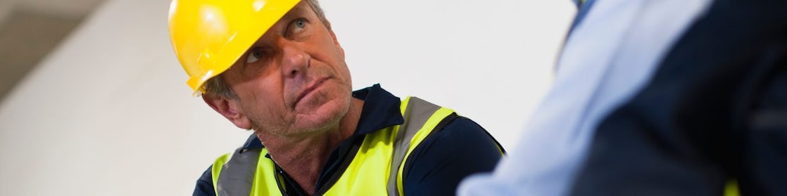 People in hardhats reviewing documents