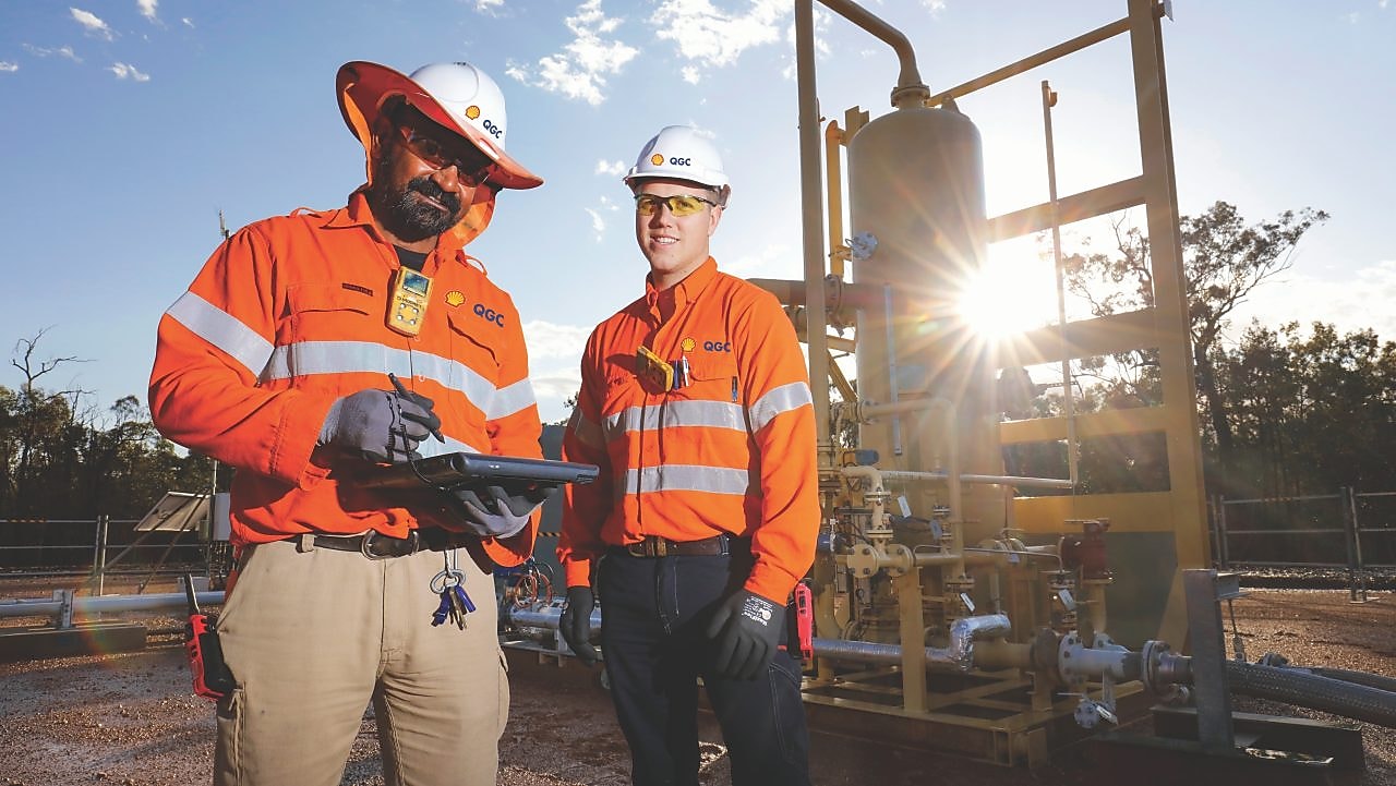 QGC wellsite operators check well performance.