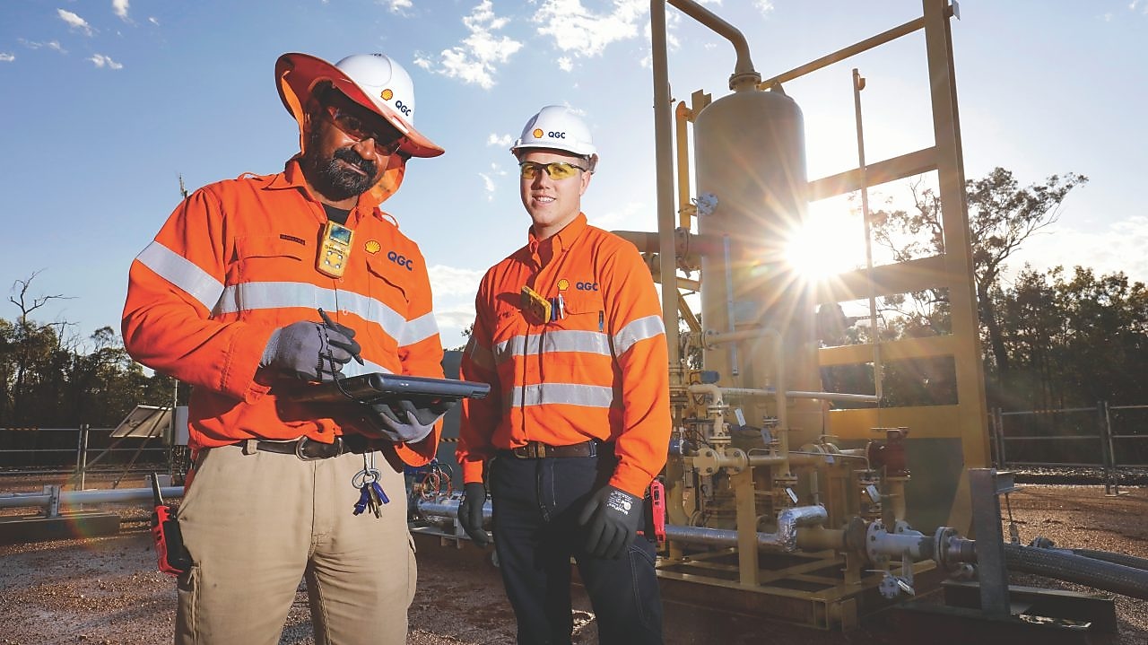 QGC wellsite operators check well performance.