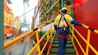 a-prelude-flng-worker-boarding-the-prelude-flng-facility-in-the-samsung-heavy-industries-yard-in-geoje-south-korea