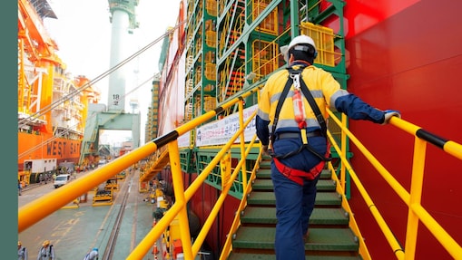 a-prelude-flng-worker-boarding-the-prelude-flng-facility-in-the-samsung-heavy-industries-yard-in-geoje-south-korea