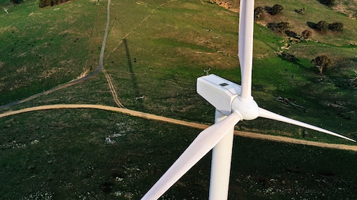 A wind turbine generating renewable electricity in a rural Australian landscape.