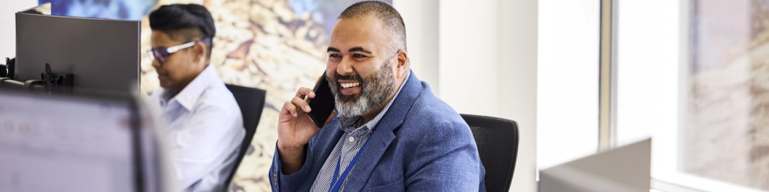 An office worker speaks on his mobile phone.