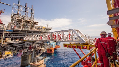Workers cross over to a new platform built alongside the existing Malampaya deep-water project