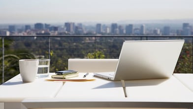 Laptop and paperwork on balcony table