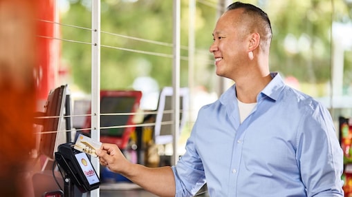 Men paying at a fuel station service with his Shell Card.