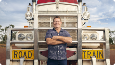 Man proudly standing in front of his truck.