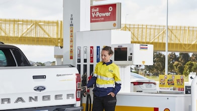 women filling fuel at shell station