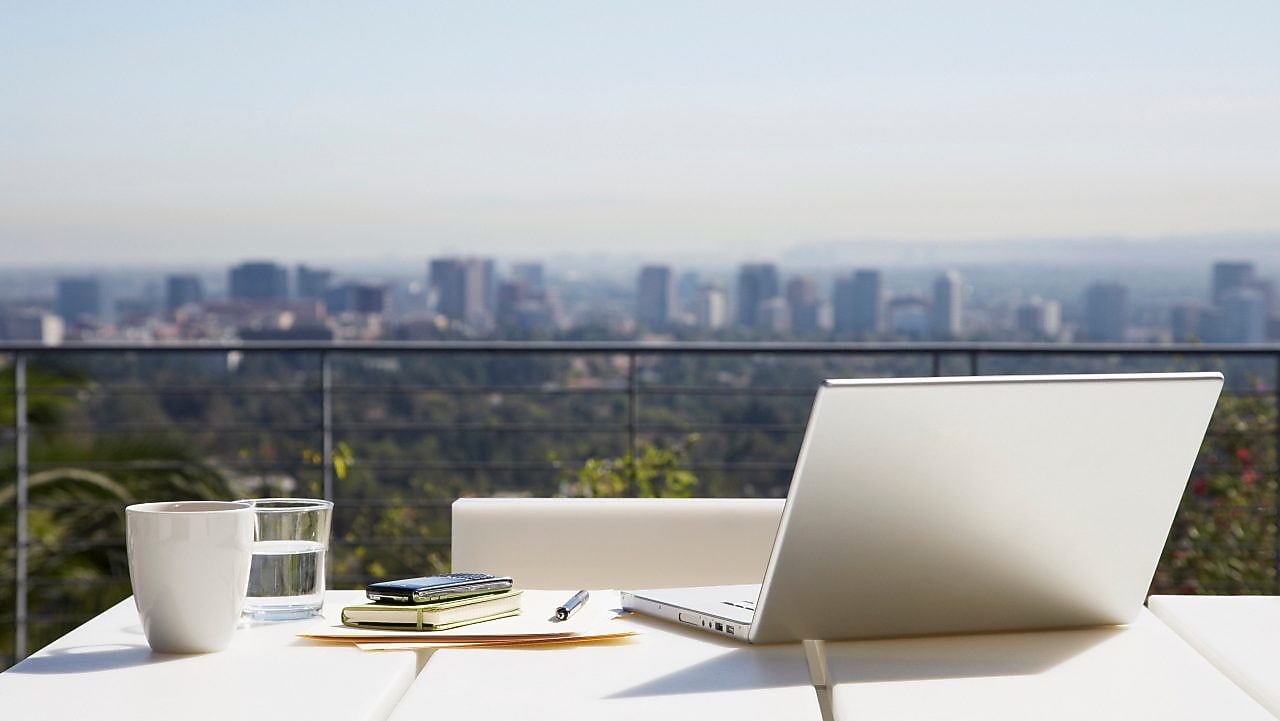 Laptop and paperwork on balcony table
