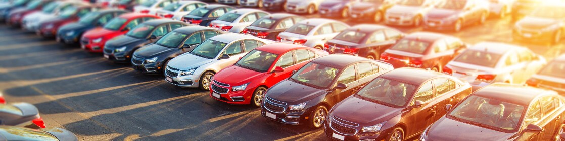 rows of cars and sunlight in the background