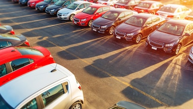 rows of cars and sunlight in the background