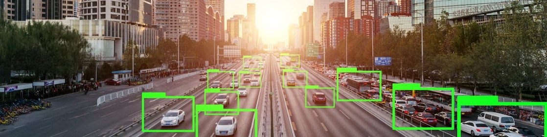 Cars on a busy city highway are highlighted with AI software
