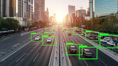 Cars on a busy city highway are highlighted with AI software