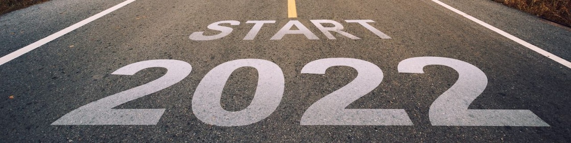Asphalt road at sunset printed with the words ‘Start 2022’