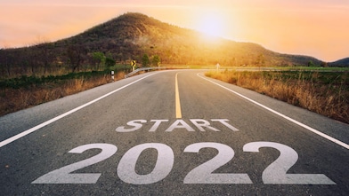 Asphalt road at sunset printed with the words ‘Start 2022’
