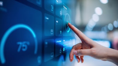 Finger pointing a screen with data