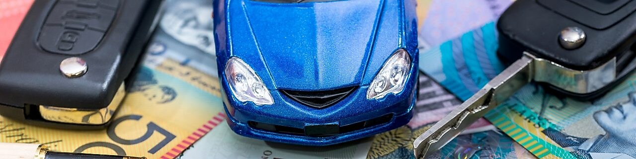 Keys, cash and cars spread out on a table