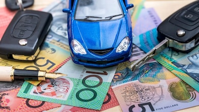 Keys, cash and cars spread out on a table