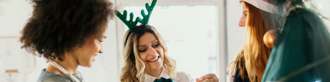 Three colleagues celebrate Christmas at work
