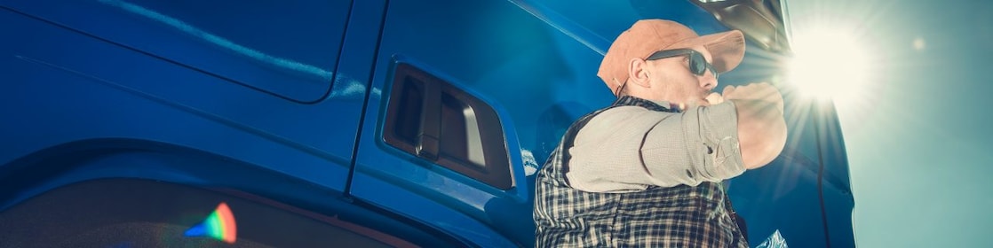 Man drinking a beverage outside his truck