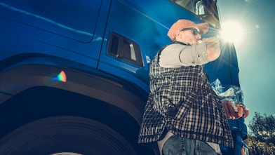 Man drinking a beverage outside his truck