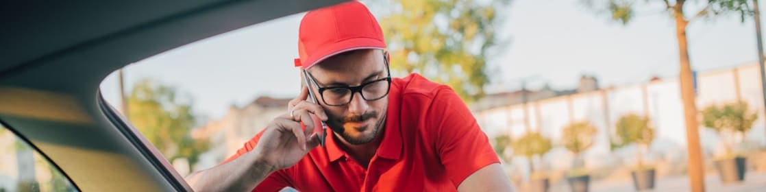 Man in his car delivering a package