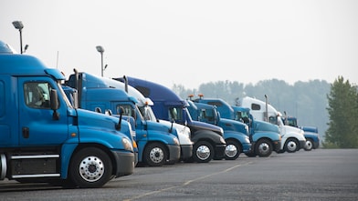 Profiles of different big rig long haul semi trucks with high cab standing on parking lot waiting for loading and possibility of continuing to the destination according to approved schedule
