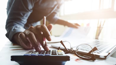 Personal entering data into a calculator