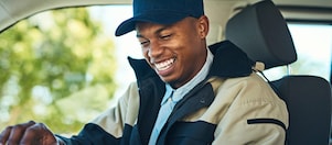 Man looking at a tablet in his vehicle